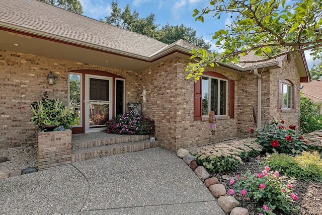 doorway to property with brick siding
