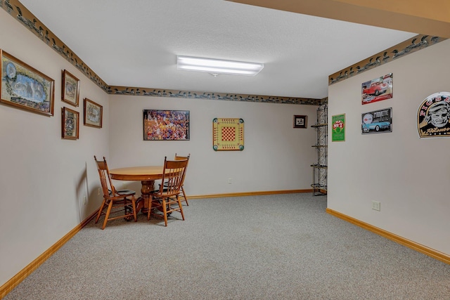 carpeted dining area featuring baseboards