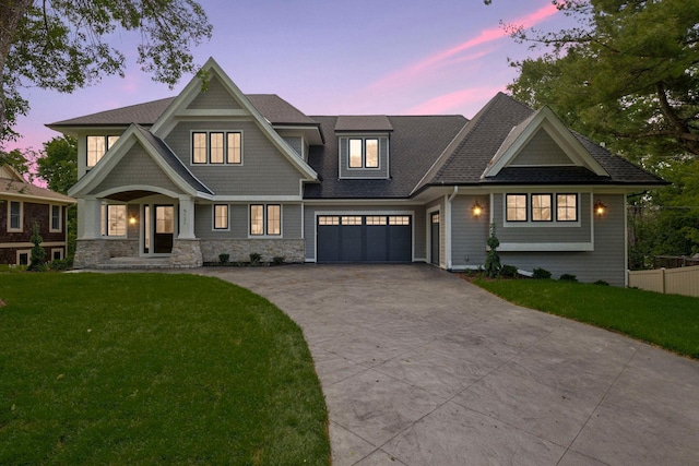 craftsman house featuring a garage and a lawn