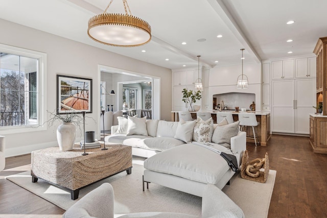 living room with beamed ceiling, dark hardwood / wood-style flooring, and sink