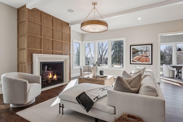 living room with a fireplace, dark hardwood / wood-style flooring, and beam ceiling