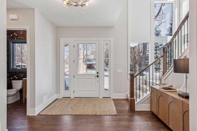entrance foyer featuring an inviting chandelier and dark wood-type flooring