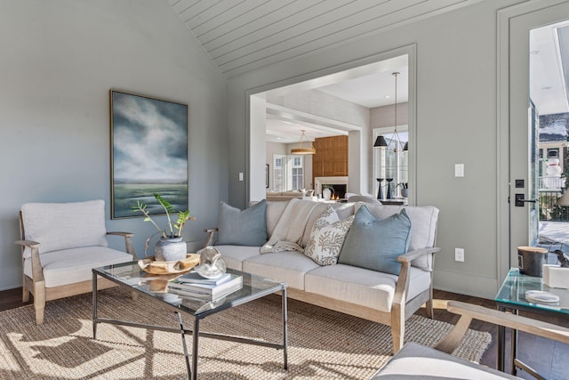 living room featuring wood-type flooring and vaulted ceiling