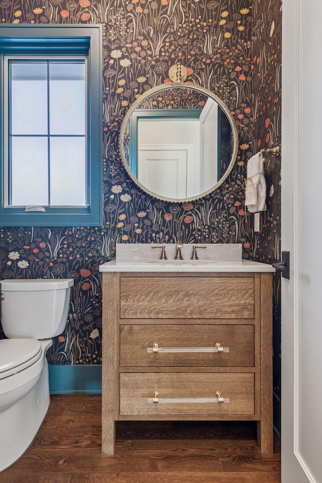 bathroom with vanity, hardwood / wood-style floors, and toilet