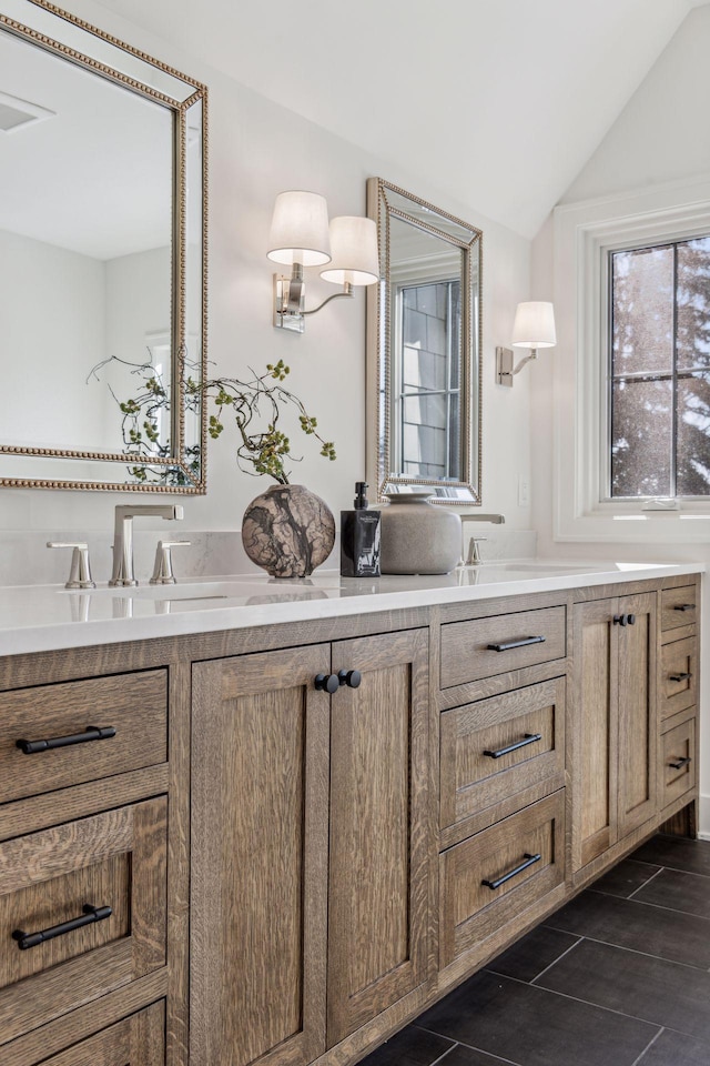 bathroom featuring vanity and vaulted ceiling