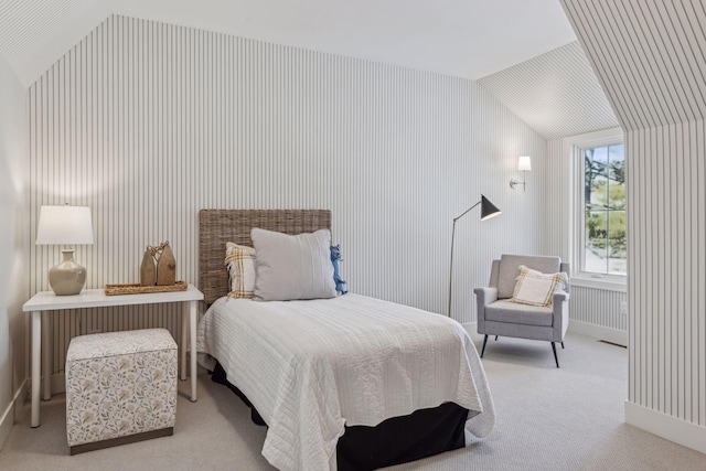 bedroom with light colored carpet and lofted ceiling