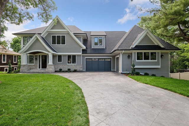 craftsman-style home with a garage and a front yard
