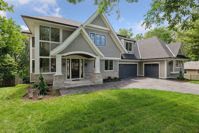 view of front of house with a porch, a garage, and a front yard