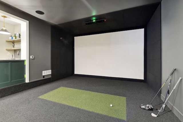 cinema featuring golf simulator, carpet flooring, and sink