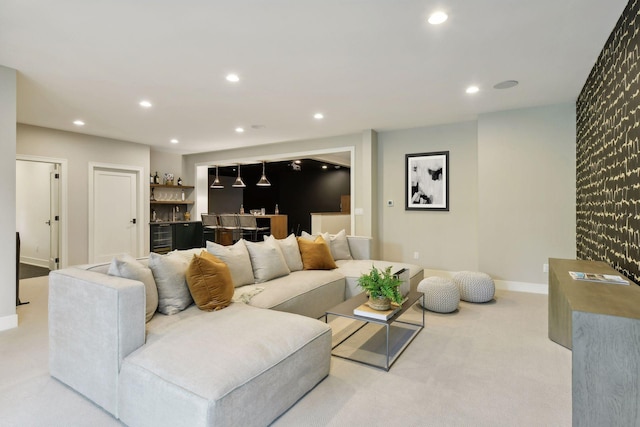 living room with light colored carpet, beverage cooler, and bar area