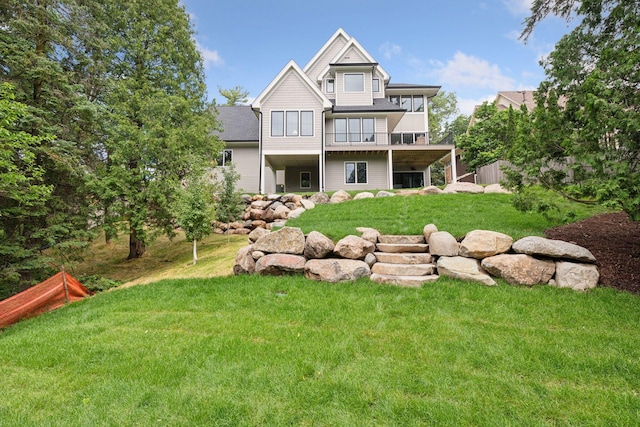 rear view of property with a lawn