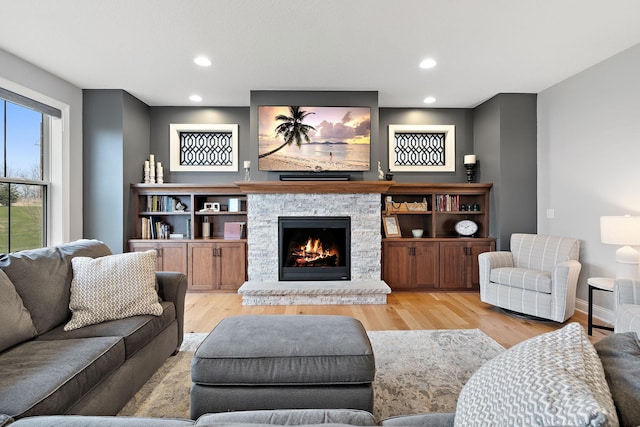 living room with a fireplace and light hardwood / wood-style floors