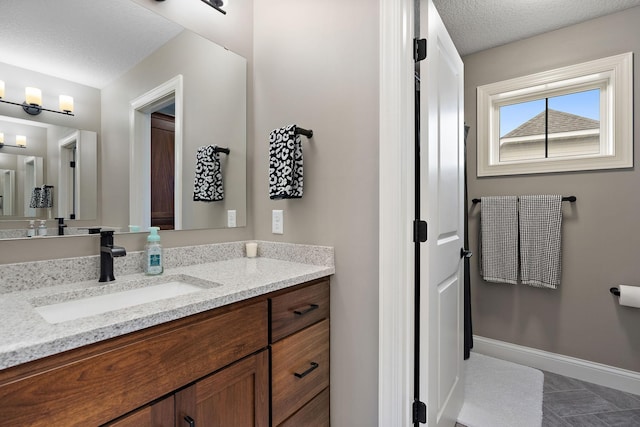 bathroom featuring vanity and a textured ceiling