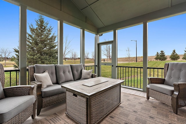 sunroom / solarium featuring plenty of natural light and vaulted ceiling