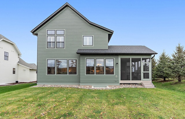 rear view of property featuring a sunroom and a yard