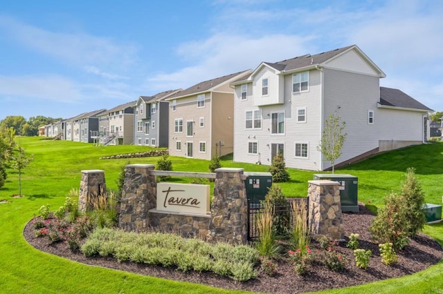 community sign with a residential view and a lawn