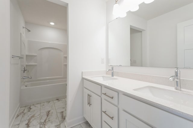 full bath featuring a sink, baseboards, marble finish floor, and double vanity