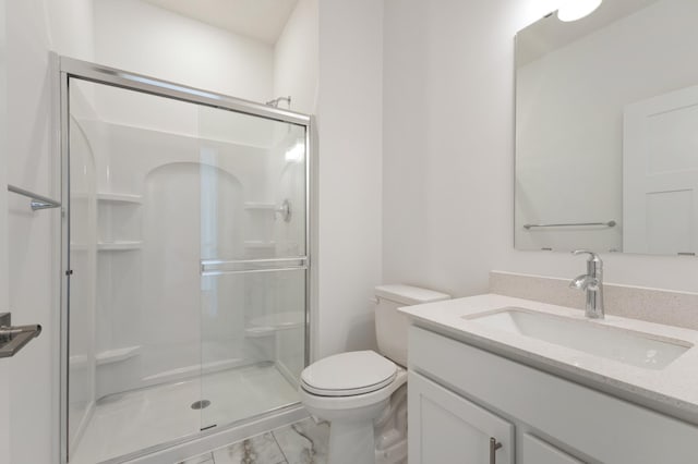 full bathroom with vanity, toilet, marble finish floor, and a shower stall