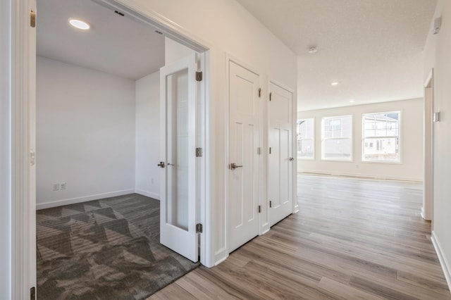 hall with hardwood / wood-style floors