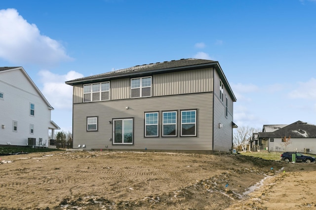 rear view of house with central AC unit