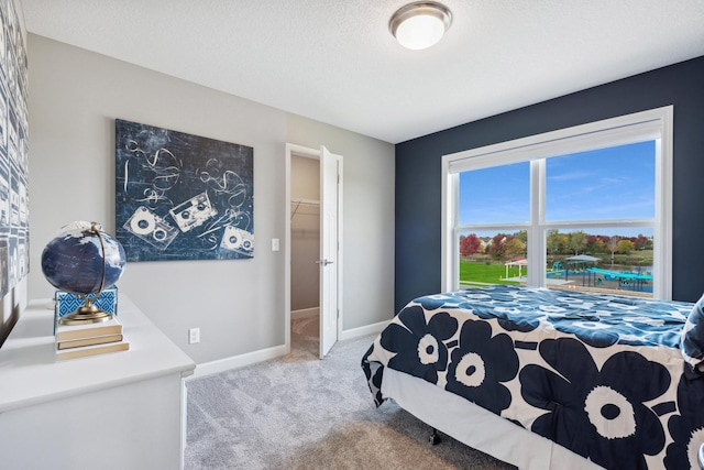 bedroom featuring a textured ceiling and carpet flooring