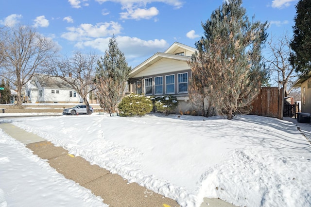 view of front of property featuring fence and central AC