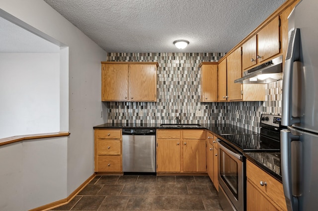 kitchen featuring tasteful backsplash, sink, stainless steel appliances, and a textured ceiling