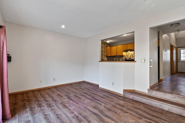 unfurnished living room with hardwood / wood-style flooring