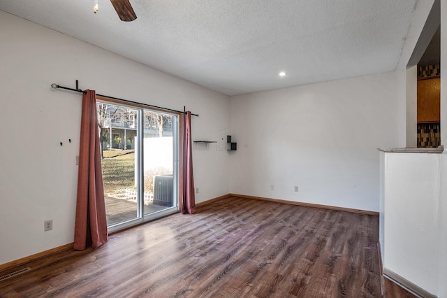 unfurnished room with ceiling fan, dark hardwood / wood-style floors, and a textured ceiling