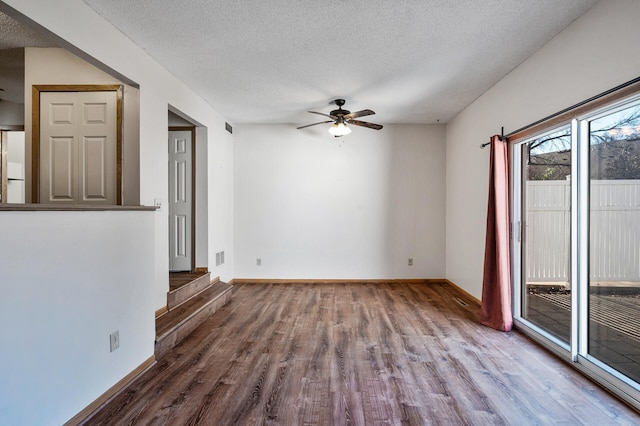 spare room featuring ceiling fan, hardwood / wood-style floors, and a textured ceiling