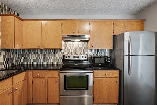 kitchen with tasteful backsplash, appliances with stainless steel finishes, and dark stone countertops