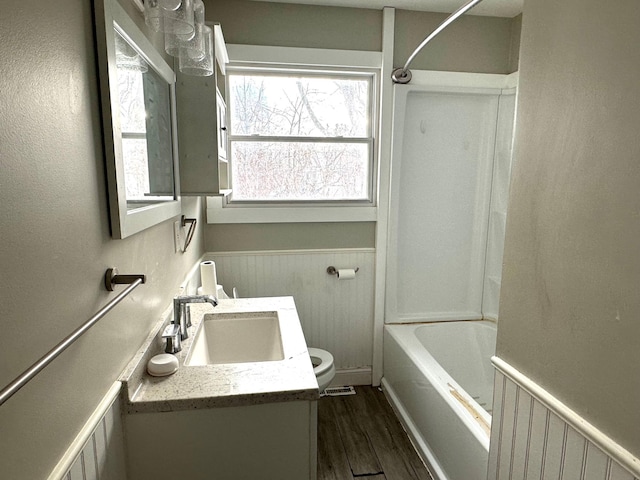 full bathroom with vanity, hardwood / wood-style floors, toilet, and shower / bath combination