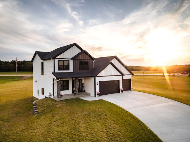 view of front of home with a garage and a lawn