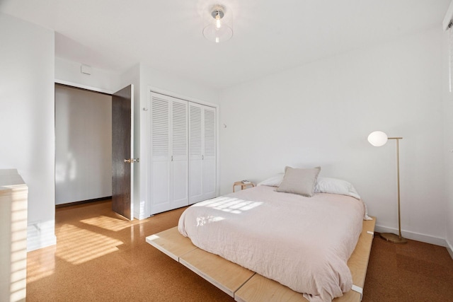 bedroom featuring a closet and baseboards