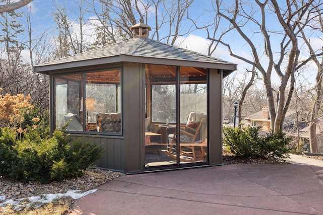 view of outdoor structure with a sunroom