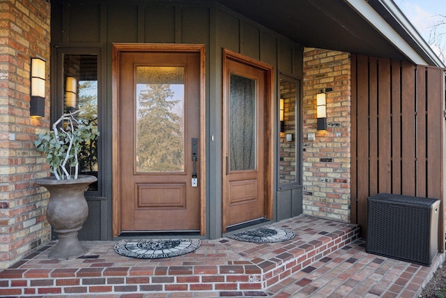 doorway to property featuring a porch and board and batten siding