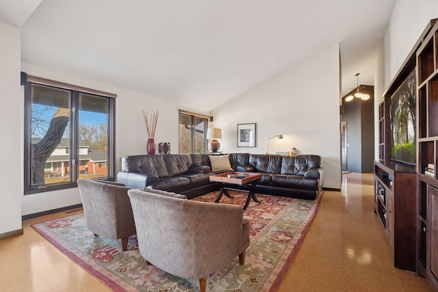 living room featuring baseboards and high vaulted ceiling