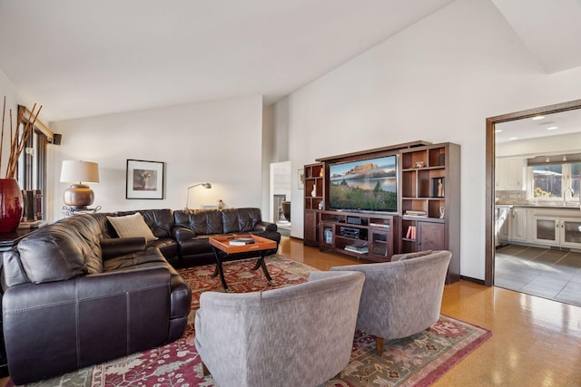 living area with high vaulted ceiling