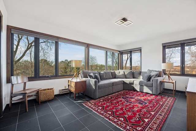 living room with dark tile patterned floors and a baseboard radiator