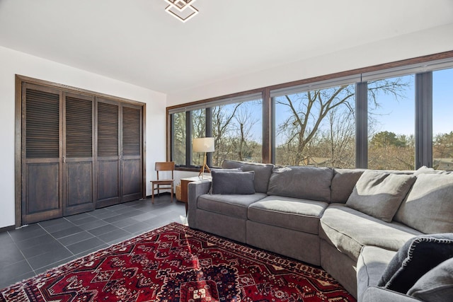 unfurnished living room featuring visible vents and dark tile patterned flooring