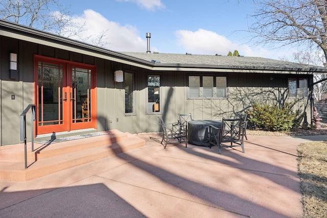 back of house with a patio area, outdoor dining space, french doors, and roof with shingles