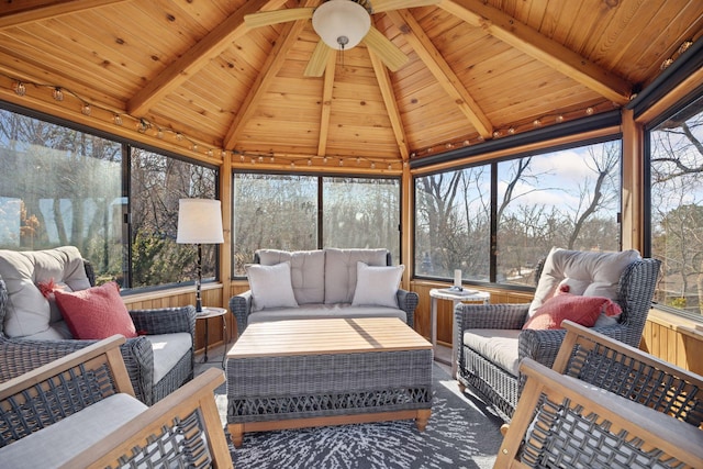 sunroom with a wealth of natural light, wood ceiling, lofted ceiling with beams, and a ceiling fan