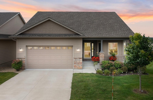 craftsman-style home featuring a garage, stone siding, concrete driveway, and roof with shingles