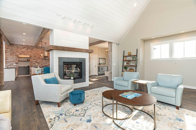 771 Zumbro Oaks Ln NW, Oronoco, MN 55960 - living area with a glass covered fireplace, brick wall, vaulted ceiling, and wood finished floors