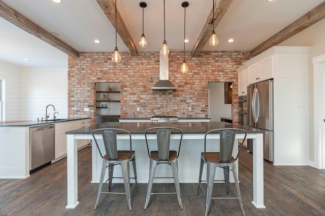 771 Zumbro Oaks Ln NW, Oronoco, MN 55960 - kitchen with wall chimney range hood, dark countertops, stainless steel appliances, dark wood-type flooring, and a kitchen island