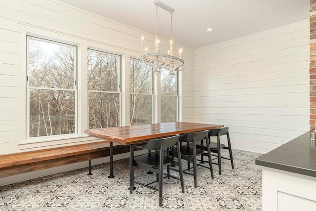 771 Zumbro Oaks Ln NW, Oronoco, MN 55960 - dining area with a chandelier, light tile patterned floors, and wooden walls