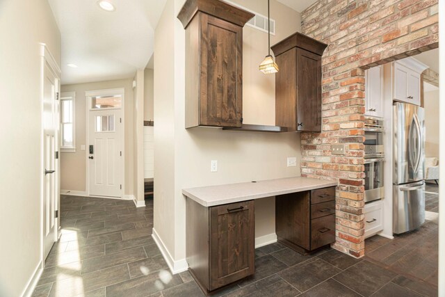 771 Zumbro Oaks Ln NW, Oronoco, MN 55960 - kitchen featuring hanging light fixtures, light countertops, baseboards, and stainless steel appliances