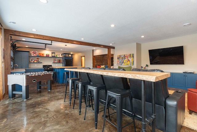 771 Zumbro Oaks Ln NW, Oronoco, MN 55960 - kitchen featuring concrete floors, a kitchen island, recessed lighting, blue cabinets, and light countertops