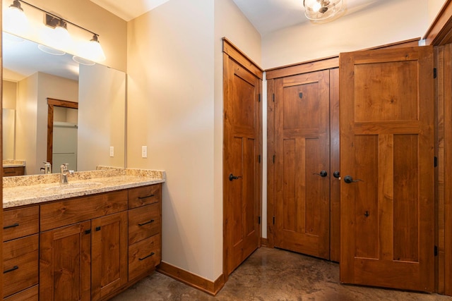 771 Zumbro Oaks Ln NW, Oronoco, MN 55960 - bathroom with concrete floors, vanity, baseboards, and a closet