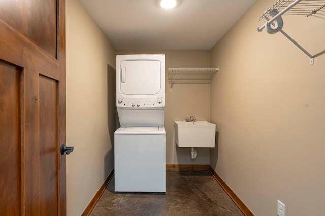771 Zumbro Oaks Ln NW, Oronoco, MN 55960 - washroom featuring baseboards, a sink, stacked washer and dryer, and laundry area